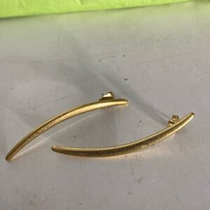 Earrings gold color no identifying marks very sleek very dramatic